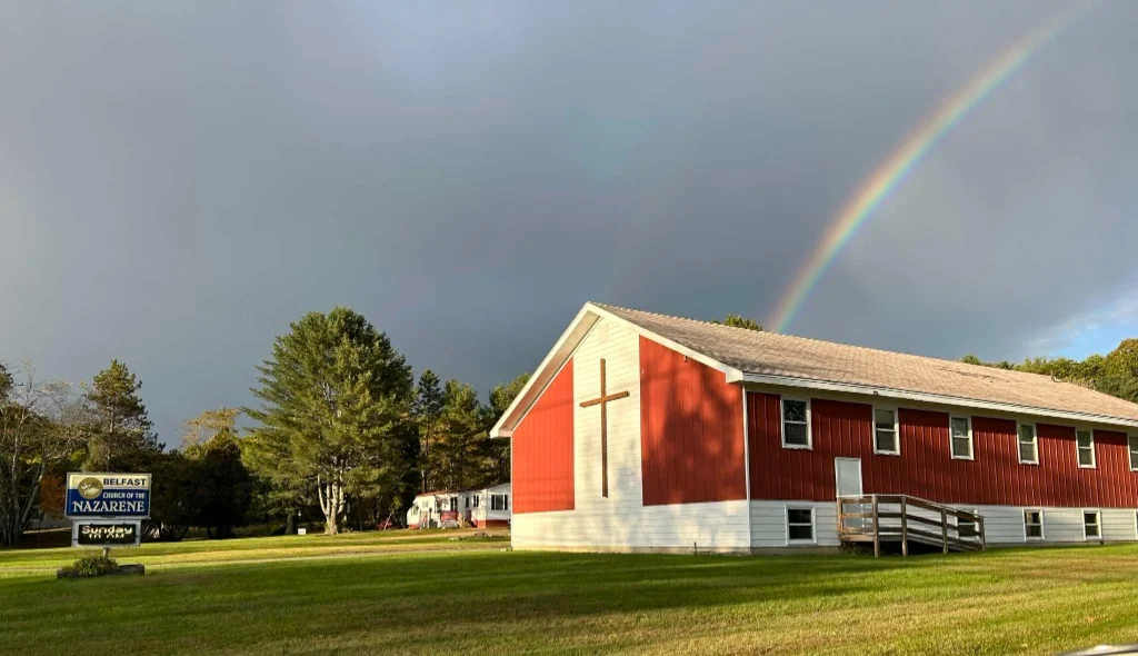 A rainbow above our red church building in Belfast, Maine